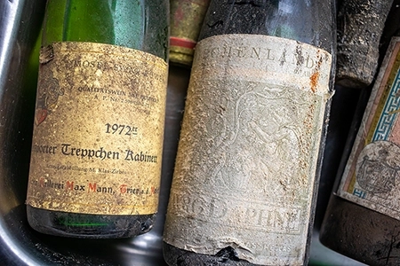 Neckargemuend, Germany - September 11, 2021: very old wine bottles with deposits from long cellar storage